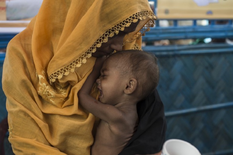 In this picture taken on October 1, 2017, a Rohingya Muslim refugee holds her child as she waits to see a doctor at a medical centre at Balukhali refugee camp near the town of Gumdhum in Coxu00e2u20acu2122s Bazar. u00e2u20acu201d AFP pic