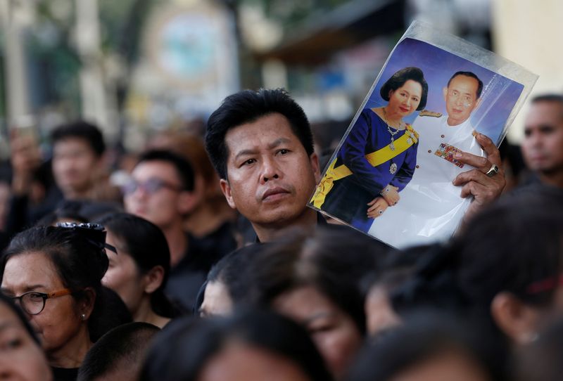 Mourners react as the Royal Urn of late King Bhumibol Adulyadej is carried by the Great Victory Chariot during a royal cremation procession at the Grand Palace in Bangkok, Thailand, October 26, 2017. u00e2u20acu201d Reuters pic
