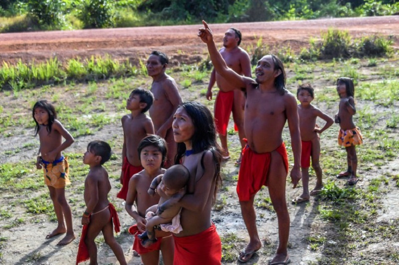 Waiapi people look at an airplane flying over the Waiapi indigenous reserve in Amapa state in Brazil October 15, 2017. u00e2u20acu201d AFP pic