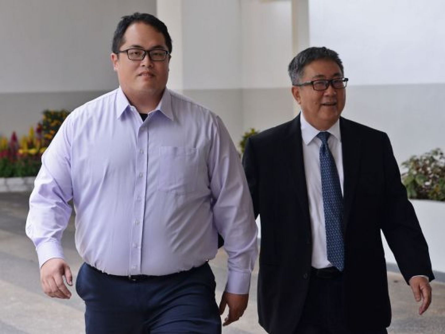 Jonathan Tan Huai En (left), the elder son of senior lawyer Tan Chee Meng (right). His younger brother, Isaac Tan, was jailed by the District Court for a similar offence. u00e2u20acu201du00c2u00a0TODAY file pic