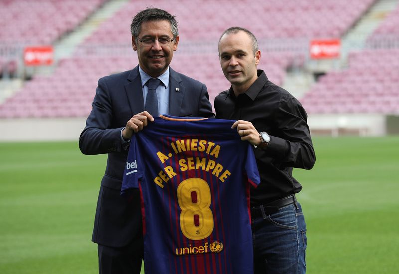 FC Barcelona captain Andres Iniesta holds up a jersey with FC Barcelonau00e2u20acu2122s President Josep Maria Bartomeu after announcing the agreement of a contract for life with FC Barcelona, in Barcelona, Spain, October 6, 2017. u00e2u20acu201d Reuters pic