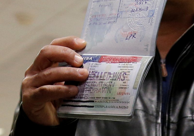 A visitor shows a cancelled visa in the passport from a failed entry into the US at at Washington Dulles International Airport in Chantilly, Virginia February 6, 2017. u00e2u20acu201d Reuters pic 