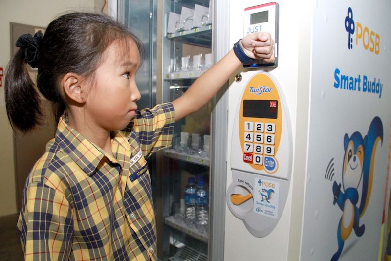 The POSB Smart Buddy programme in Singapore primary schools will use wearable technology to teach students how to save and spend, with features such as transaction histories and savings goals. u00e2u20acu201d TODAY pic
