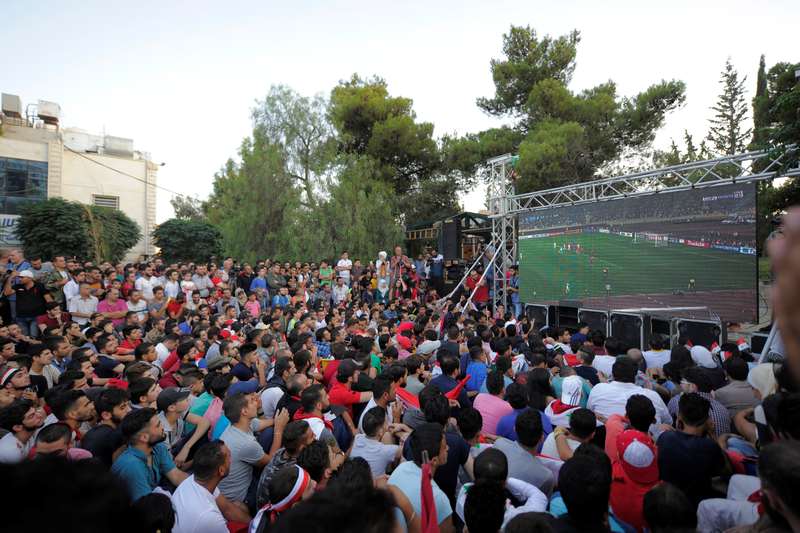 People gather as they watch a telecast of the 2018 World Cup qualifiers between Iran and Syria in Damascus September 5, 2017. u00e2u20acu201d Reuters pic