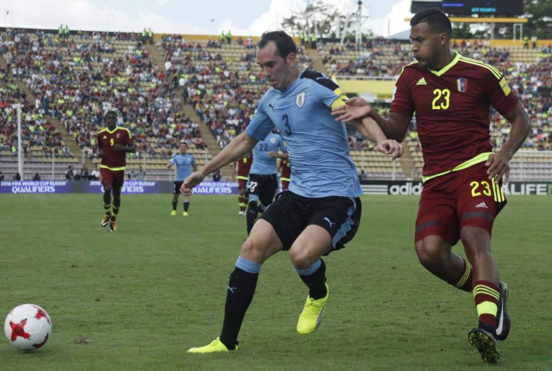 Uruguay's Diego Godin and Venezuela's Salomon Rondon in action during the World Cup qualifier match in San Cristobal, Venezuela. u00e2u20acu2022 Reuters pic