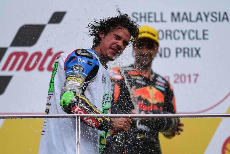 Franco Morbidelli (left) is sprayed with champagne on the podium by first placed Miguel Oliveira after clinching the Moto2 world championship at the Sepang International Circuit October 29, 2017. u00e2u20acu201d AFP pic