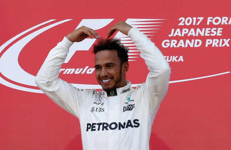 Mercedes' Lewis Hamilton of Britain gestures as he celebrates winning the Japanese Grand Prix. u00e2u20acu2022 Reuters pic