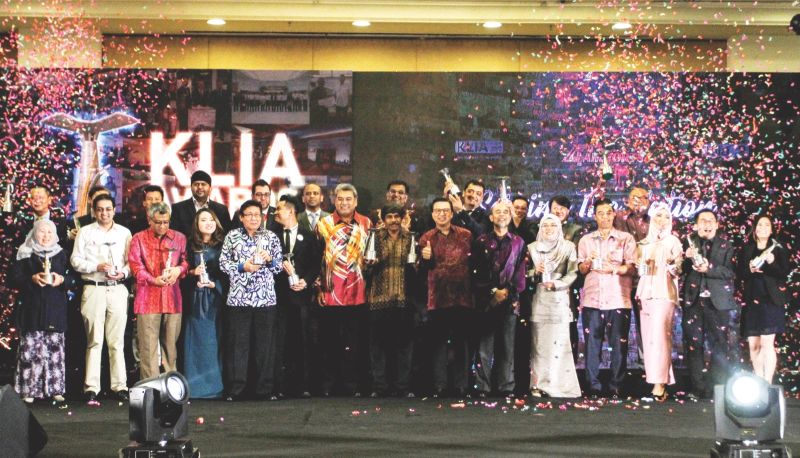 Liow gives the thumbs-up with the winners and MAHB officials on stage. u00e2u20acu201d Picture by Shafwan Zaidon
