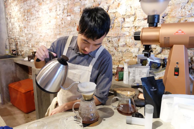 The making of coffee...Joachim Leong pouring the coffee for a filtered coffee.