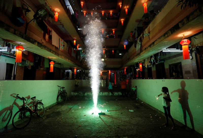 A girl plays with firecrackers while celebrating the Hindu festival of Diwali, the annual festival of lights in Mumbai October 19, 2017. u00e2u20acu201d Reuters pic