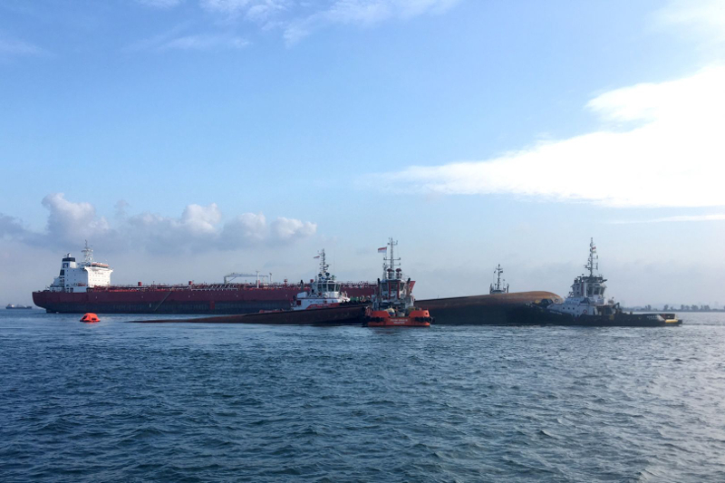 Four tug boats moving the partially submerged dredger safely to an area near Pulau Senang for follow up underwater search operation. u00e2u20acu201d Picture by Maritime Port Authority of Singapore via TODAY