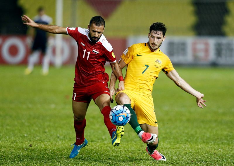 Syriau00e2u20acu2122s Ouday Abdul Jaffal and Australiau00e2u20acu2122s Mathew Leckie fight for the ball during their 2018 World Cup Qualifying Asia Zone playoffs at Hang Jebat Stadium, Melaka, October 5, 2017. u00e2u20acu201d Reuters pic