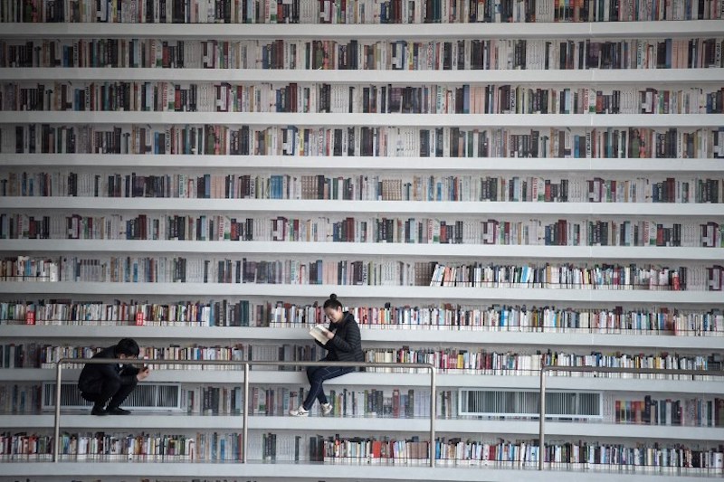 A woman reads at the Tianjin Binhai Library November 16, 2017. — AFP pic