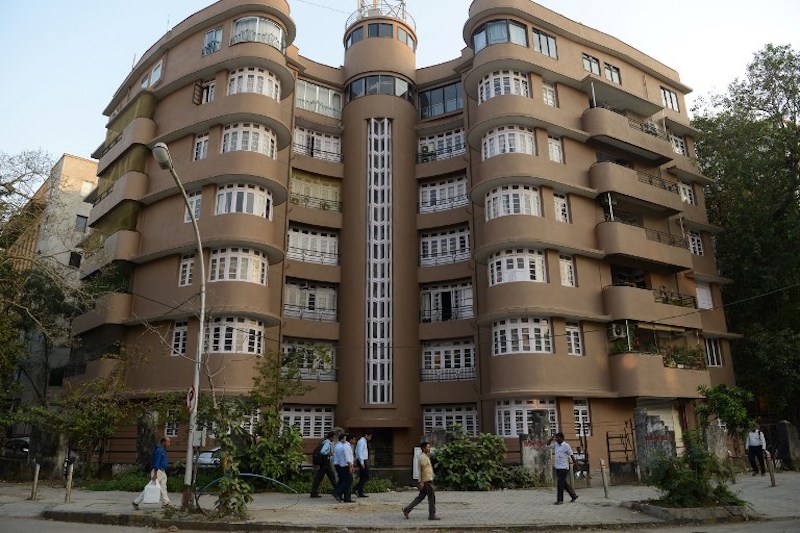 Pedestrians pass by an Art Deco building near Marine Drive in Mumbai November 8, 2017. — AFP pic