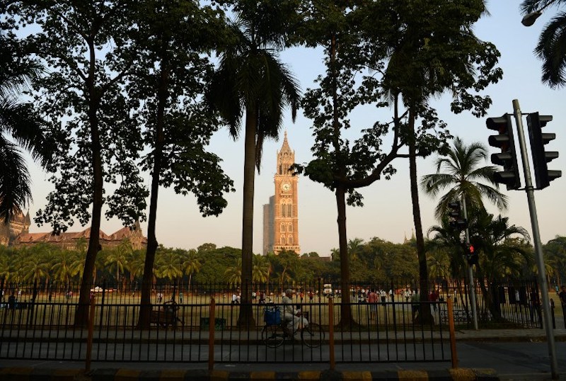 Pedestrians walk past the Rajabai Clock Tower in south Mumbai November 8, 2017. u00e2u20acu201d AFP pic