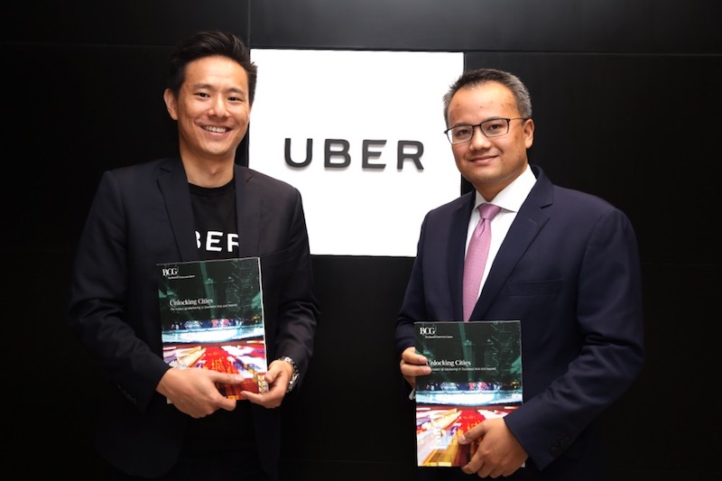 Uber Malaysia and Singapore general manager Warren Tseng and partner and Managing Director of the Boston Consulting Group Rick Ramli holding the Unlocking Citiesu00c2u00a0report. u00e2u20acu201d Picture by Choo Choy May