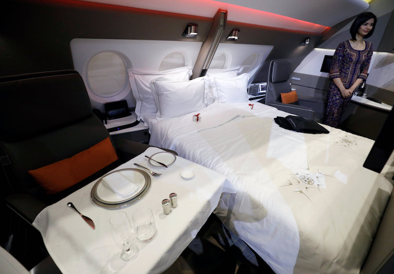 A flight attendant presents the newly launched First Class Suite cabin during a Singapore Airlines event in Singapore November 2, 2017. — Reuters pic