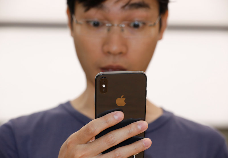 A man tries out the Animoji feature on an iPhone X during its launch at the Apple store in Singapore November 3, 2017. u00e2u20acu201d Reuters pic