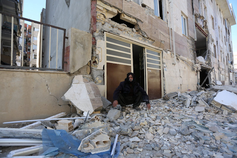A man sits outside a damaged belonging following an earthquake in Sarpol-e Zahab county in Kermanshah, Iran November 13, 2017. u00e2u20acu201d Reuters pic