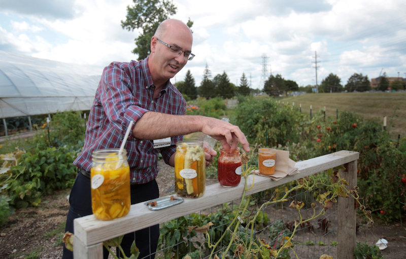 Dr Brian Halloran. a vascular surgeon at Saint Joseph Mercy Ann Arbor, shows the canned vegetables from his garden across from Saint Joseph Mercy hospital in Ypsilanti, Michigan, August 23, 2017. u00e2u20acu201d Reuters pic