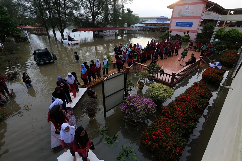 Students using tables to cross the flood waters to sit for their SPM Examination at Sekolah Menengah Kebangsaan Datuk Ahmad Said in Penang November 6, 2017. u00e2u20acu201d Picture by Sayuti Zainudin
