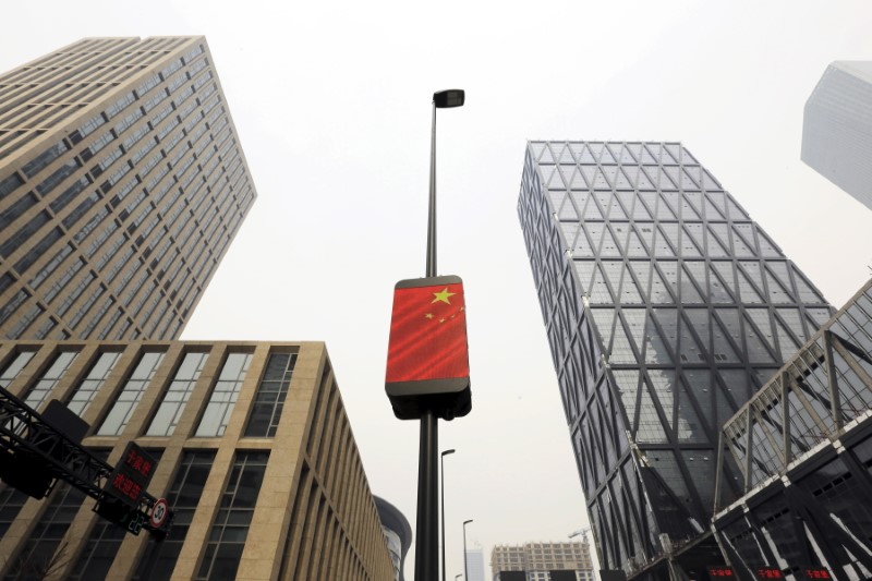 A Chinese national flag is seen among buildings at the Yujiapu financial centre, in Tianjin, China February 22, 2016. u00e2u20acu201d Reuters pic