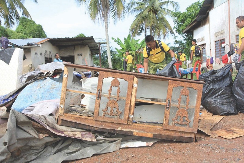 Rela members help in the big clean-up after the floods.