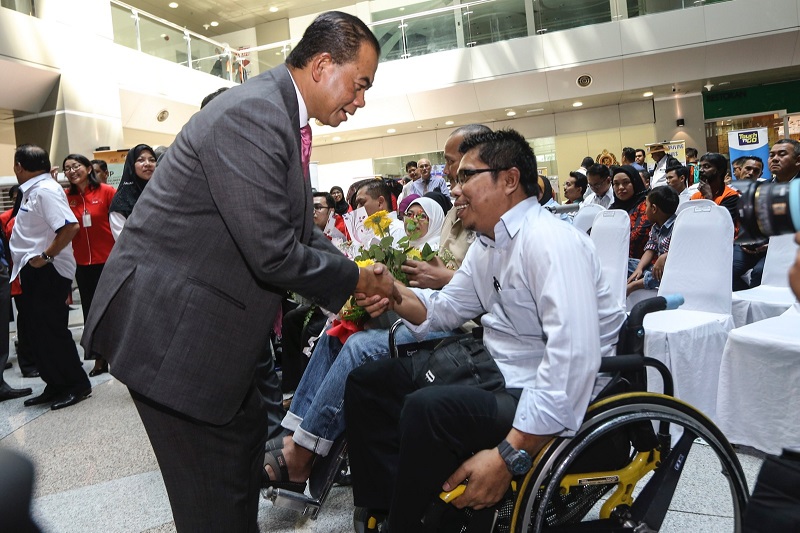 Deputy Transport Minister Datuk Aziz Kaprawi greets a road accident survivor Azhari Ibrahim during the Remembrance Day event in Putrajaya yesterday. u00e2u20acu201d Picture by Azneal Ishak