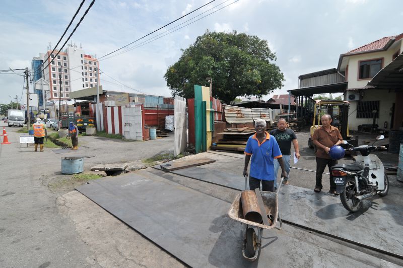 The row of scrap metal and auto parts shops along Jalan Kampung Gajah.