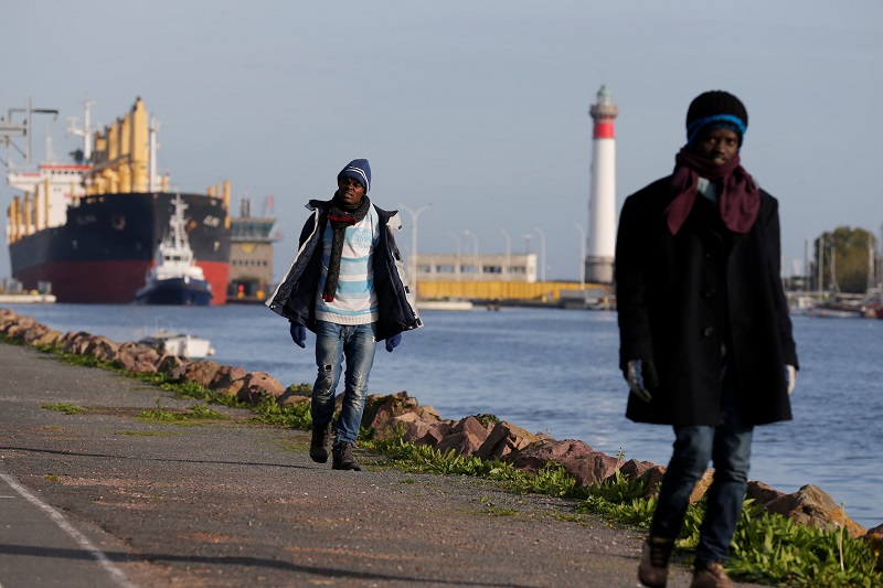 Sudanese migrants walk along the bank, as a cargo ship makes its way along the Caen channel to the sea in Ouistreham, France, October 31, 2017. u00e2u20acu201d Reuters pic