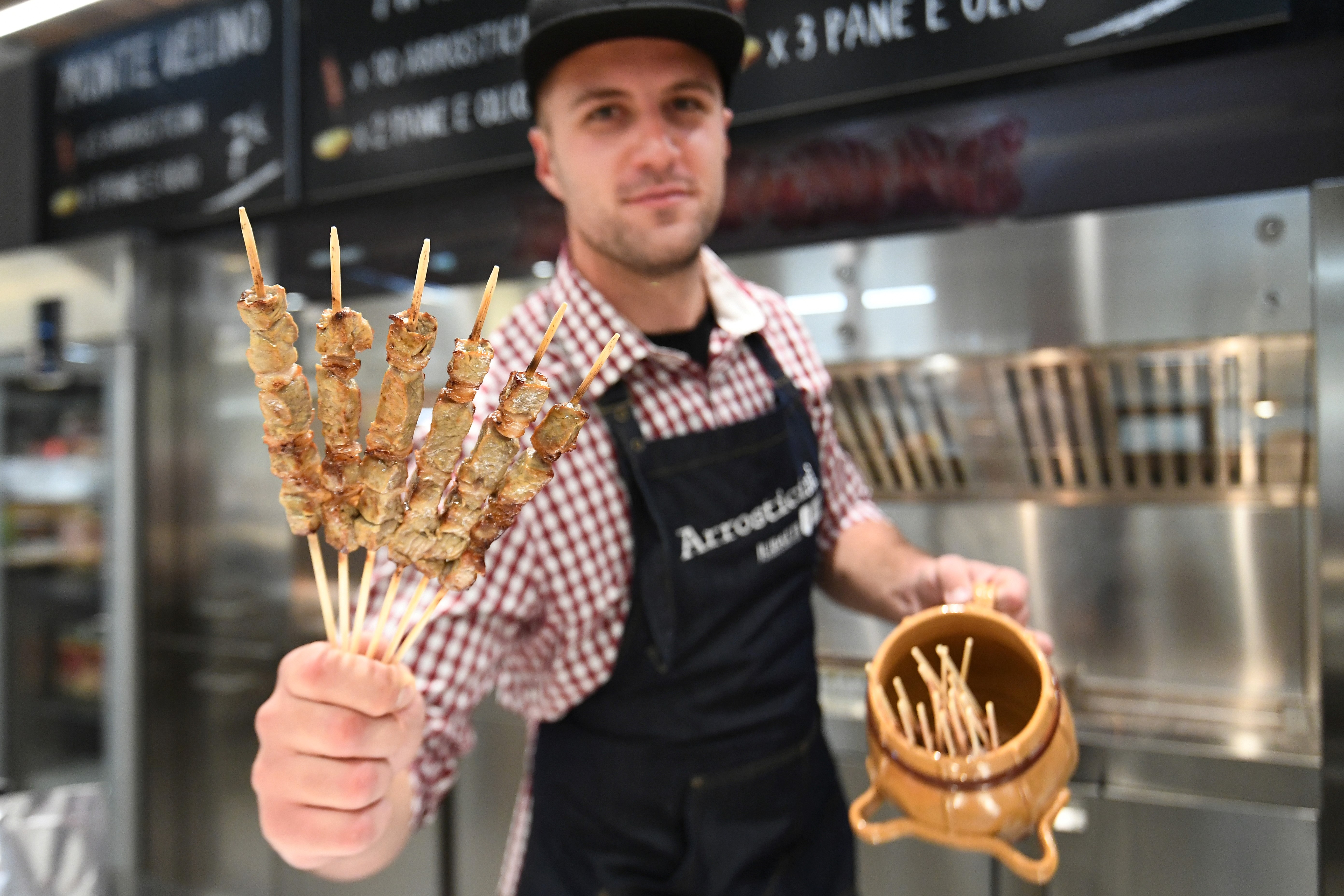A vendor presents special Italian sheep 'kebab' at a stand during a press tour at FICO Eataly World agri-food park in Bologna on November 9, 2017. u00e2u20acu201d AFP pic