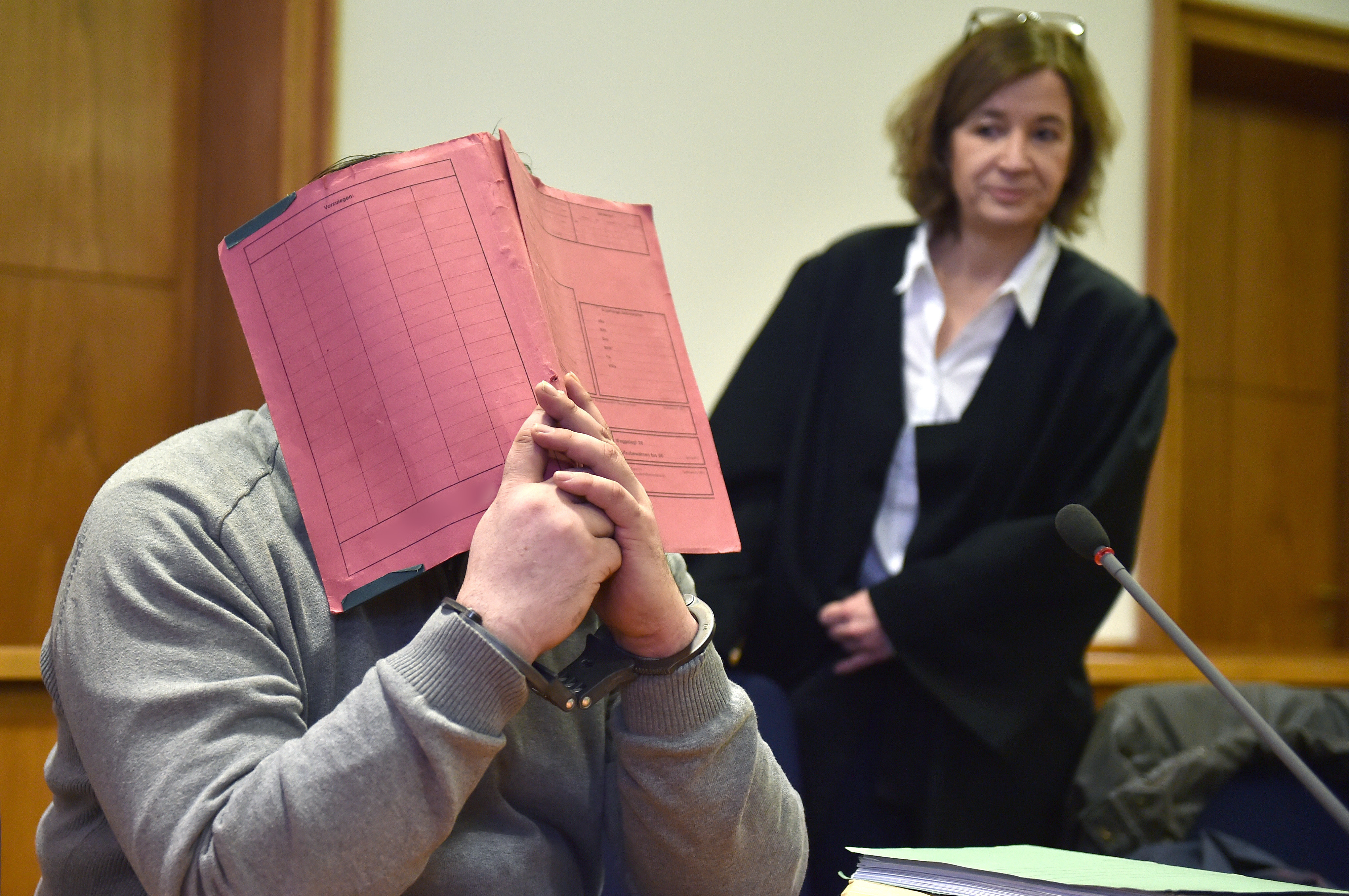 This file photo taken on February 26, 2015 shows Niels Hoegel hiding as he waits next to his lawyer Ulrike Baumann for the opening of his trial at court in Oldenburg, northwestern Germany. u00e2u20acu201d AFP pic 