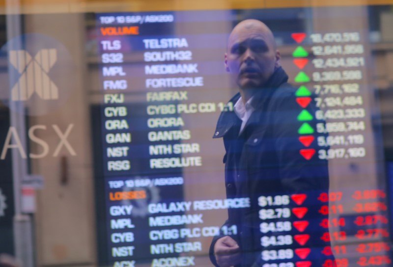 An investor is reflected in a window displaying a board showing stock prices at the Australian Securities Exchange (ASX) in Sydney July 17, 2017. u00e2u20acu201d Reuters pic