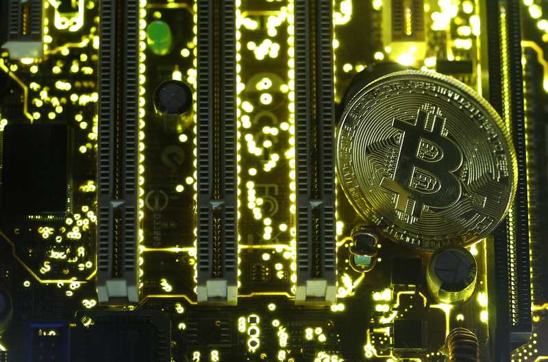 A copy of bitcoin standing on PC motherboard is seen in this illustration picture October 26, 2017. u00e2u20acu201d Reuters pi