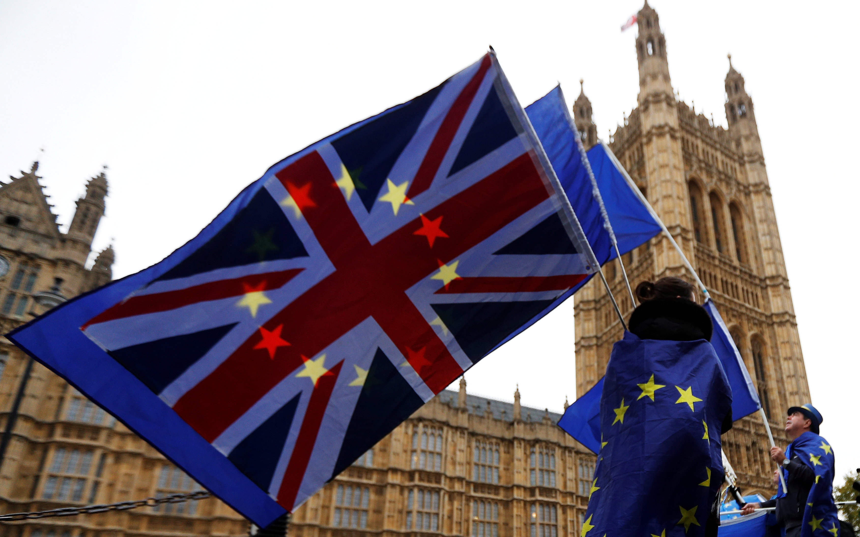 Anti-Brexit protesters wave EU and Union flags outside the Houses of Parliament in London, Britain, November 14, 2017. u00e2u20acu201d Reuters pic 