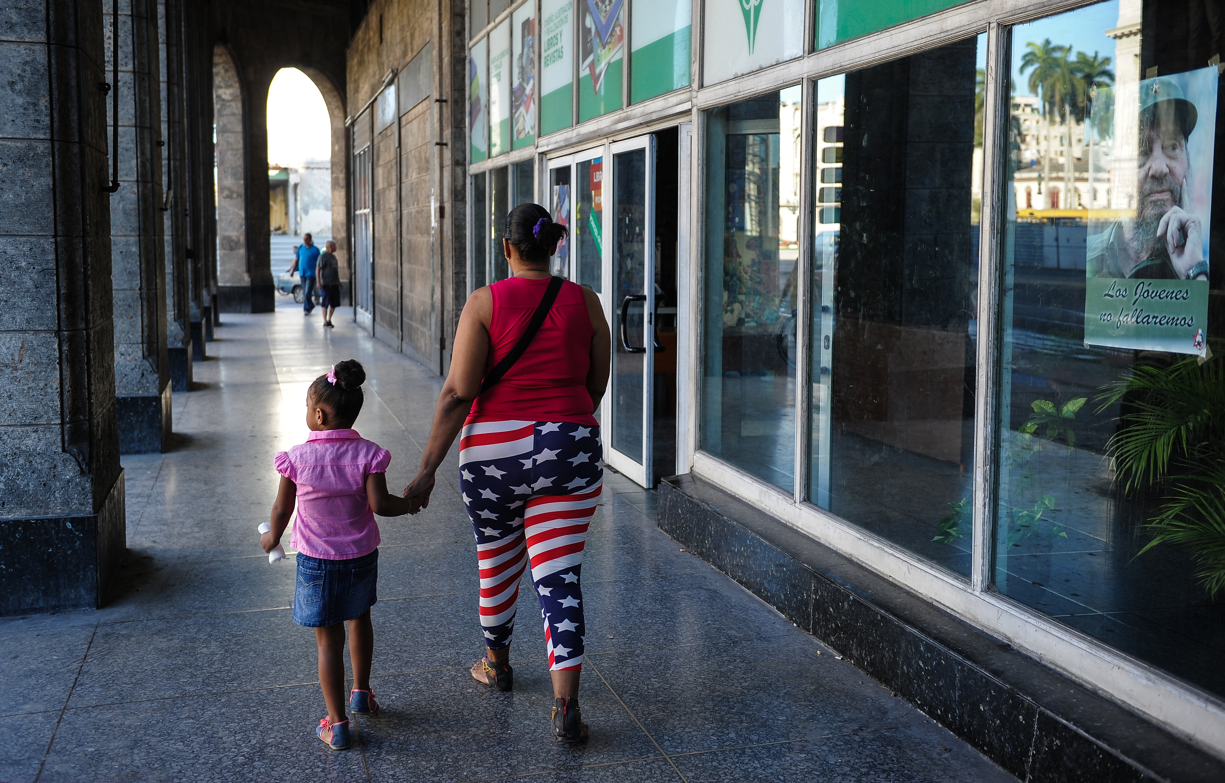A woman wearing leggings with the US flag design walks in Havana, on November 8, 2017. u00e2u20acu201d AFP pic 