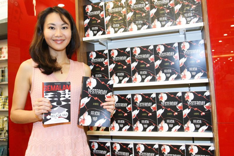 Author Felicia Yap poses with her books during a book signing event at MPH Mid Valley in Kuala Lumpur November 1, 2017. u00e2u20acu2022 Picture by Miera Zulyana