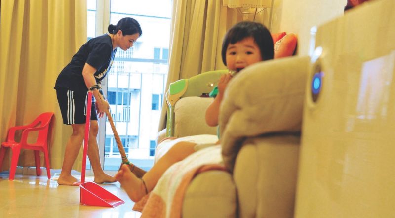 A foreign domestic helper at work in Penang. The government says with job specification and minimum wage demanded by Indonesia and the Philippines, it is not feasible to have three maids in one household to do three different tasks. u00e2u20acu2022 Malay Mail pic