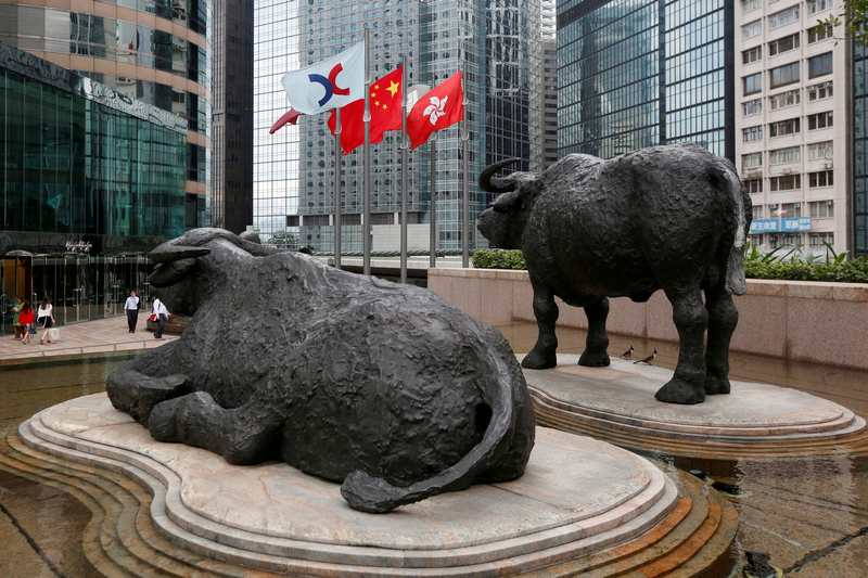 From left: The Hong Kong Exchanges flag, Chinese national flag and Hong Kong flag are hoisted outside the Hong Kong Stocks Exchange in Hong Kong June 7, 2016. u00e2u20acu201d Reuters pic