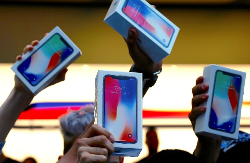 The first customers to buy the iPhone X hold it aloft during the global launch of the new Apple product in central Sydney November 3, 2017.u00e2u20acu2022 Reuters pic