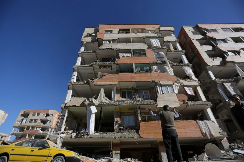 A man reacts as he looks at a damaged building in Sarpol-e Zahab county in Kermanshah, Iran November 13, 2017. u00e2u20acu201d Reuters picn