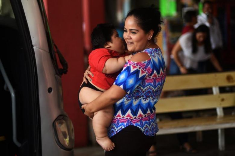 Isabel Pantoja, 24, holds her 10-month-old baby Luis Gonzales as they wait at the bus station in Colima city November 9, 2017. u00e2u20acu201d AFP pic
