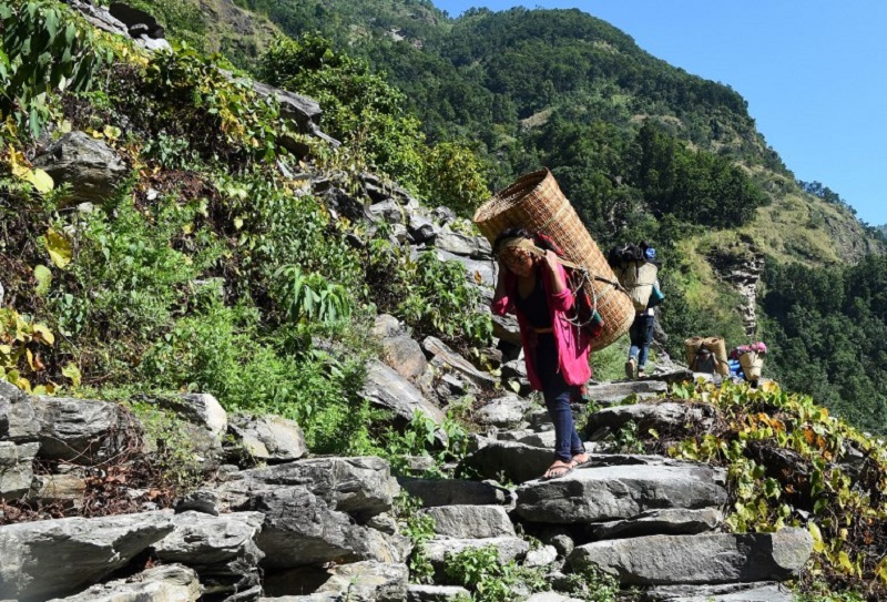 In this photograph taken on October 6, 2017, Nepali woman carry goods along a restored trails in Dhading, some 100km northwest of Kathmandu. u00e2u20acu201d AFP pic
