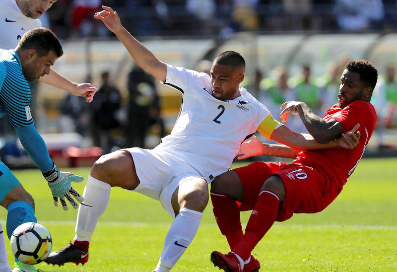 New Zealand goalkeeper Stefan Marinovic stops the ball as team-mate Winston Reid (centre) pushes away Jefferson Farfan of Peru in their World Cup qualifying playoff in Wellington November 11, 2017. u00e2u20acu201d Reuters pic