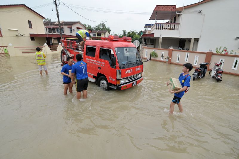 Fire rescue volunteers are seen handing out bottles of water to flood evacuees in Sungai Dua November 6, 2017. u00e2u20acu201d Picture by KE Ooi