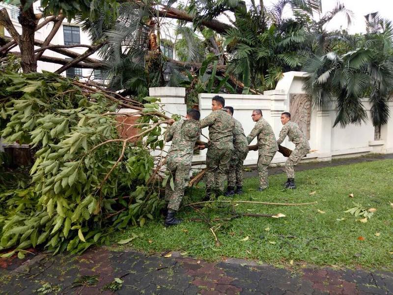 MAF personnel help to remove an uprooted tree in George Town today. — Picture via Facebook.com/HishammuddinHussein