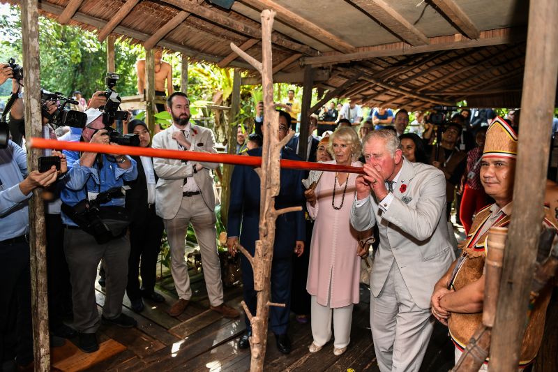 Britain's Prince Charles tries a blowpipe, a weapon of the indigenous people of Sarawak, as Camilla, Duchess of Cornwall looks on at the Sarawak Cultural Village in Santubong, on the island of Borneo November 6, 2017. u00e2u20acu201d AFP pic