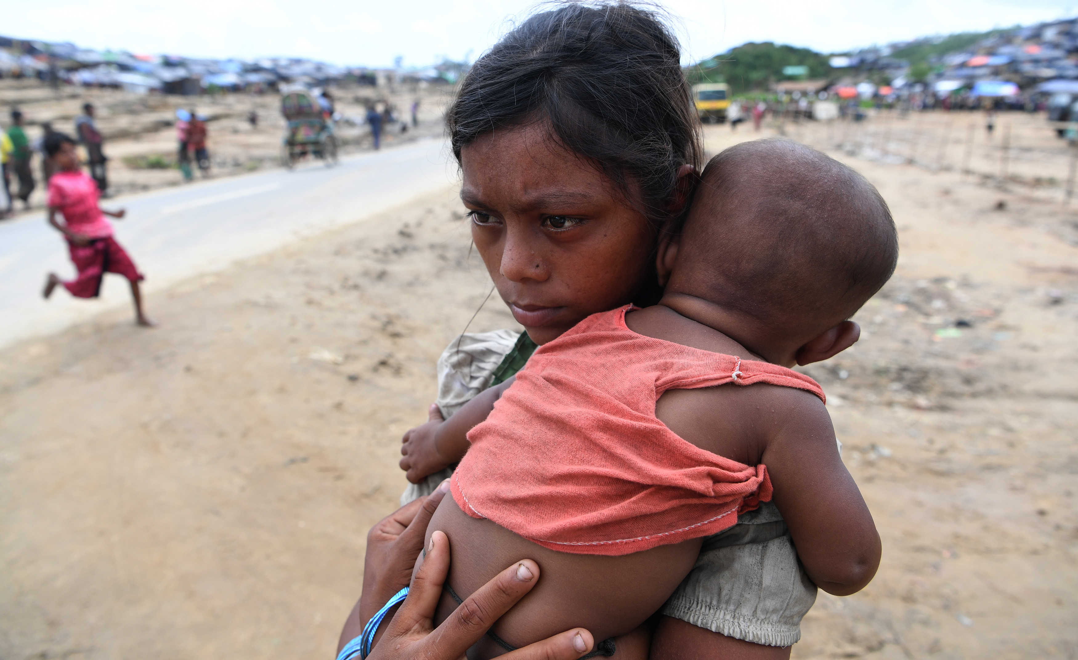 A Rohingya refugee child craddles her younger sibling at the Palangkhali refugee camp in Ukhia district on October 12, 2017.  u00e2u20acu201d AFP pic 