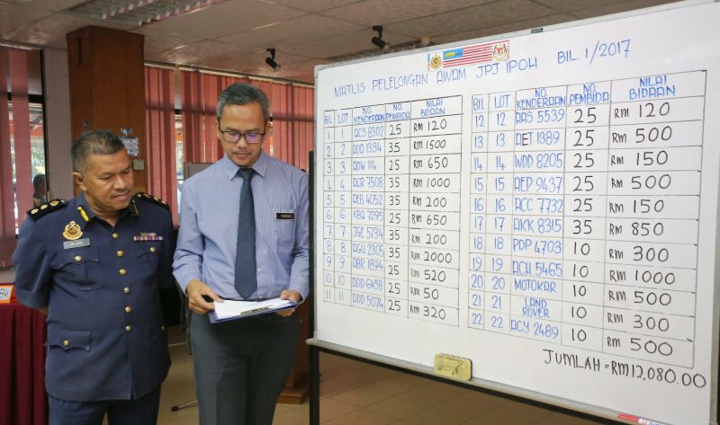 The Perak RTD's second public auction for seized vehicles attracted intense bidding for the 17 motorcycles, four cars and one lorry, held in Ipoh today collected RM12,080 in one-and-a-half hours. u00e2u20acu2022 Picture by Marcus Pheong