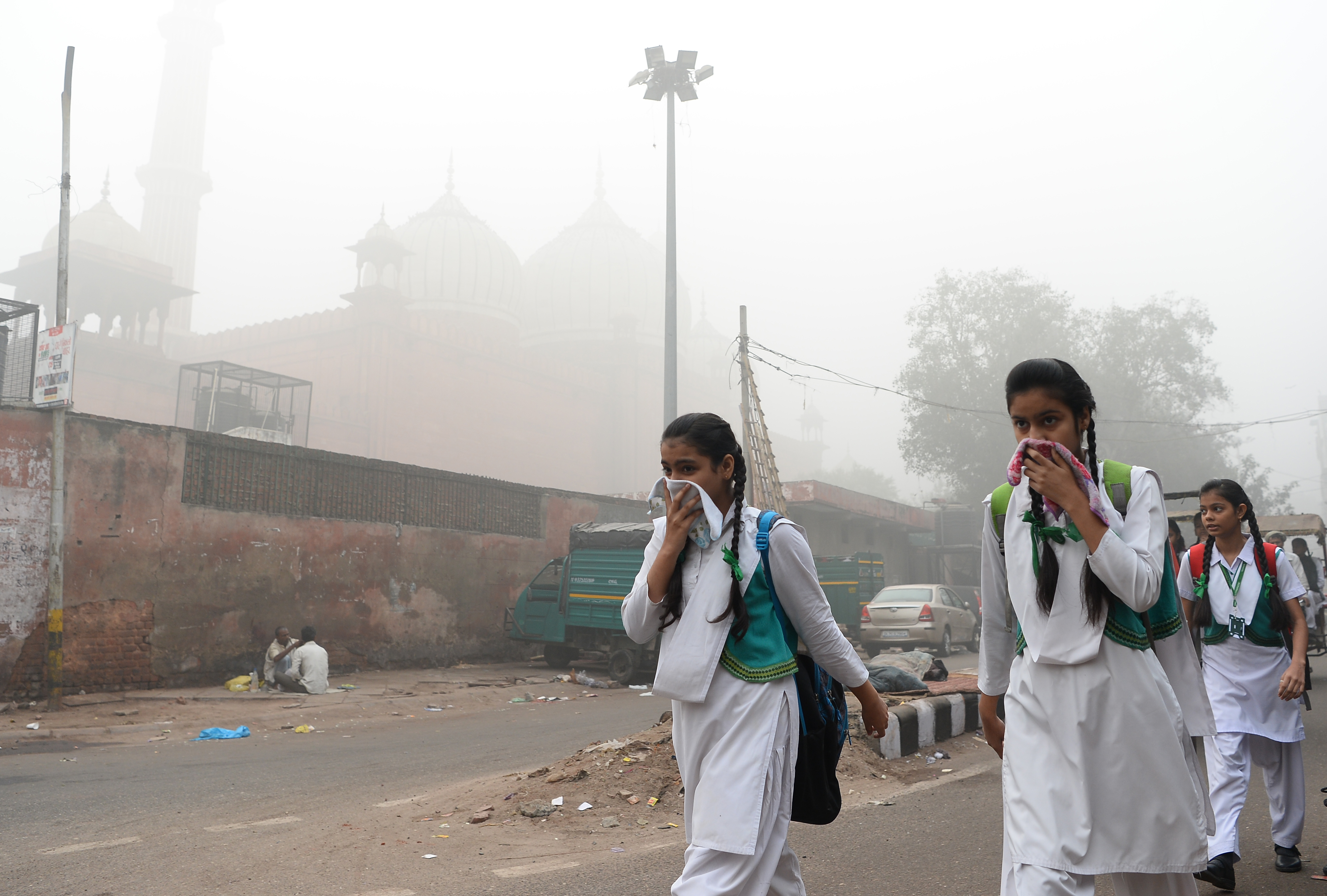 Indian schoolchildren cover their faces as they walk to school amid heavy smog in New Delhi on November 8, 2017. u00e2u20acu201d AFP pic 